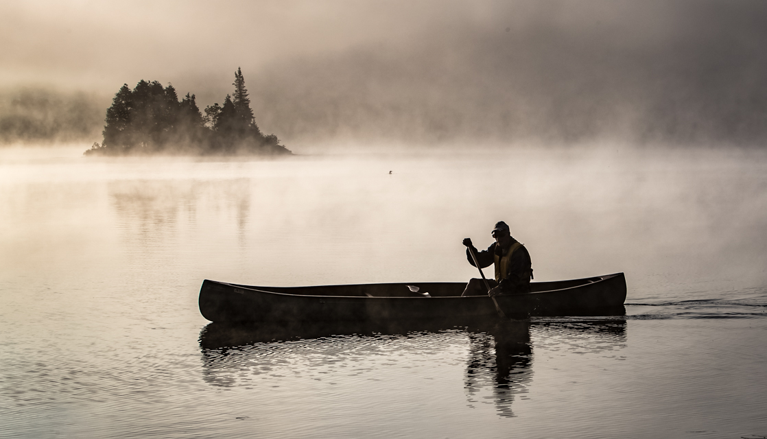 Canoe paddler on Oxtongue Lake Dock, Ontario